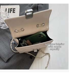Internal view of a quilted chain bag showing space for phone and makeup items