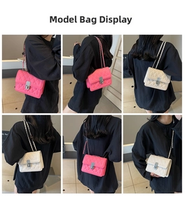 Quilted crossbody bag with chain strap and metal lock shown in pink and beige colors