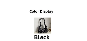 Close-up of black shoulder bag with white bow pattern and pleated cloud handle detail