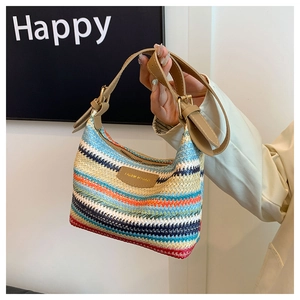 Detail of colorful striped woven pillow bag with leather strap and fashion tag