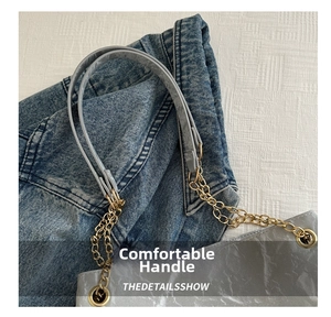 Detail of light gray textured tote with golden chain strap and leather handle joint