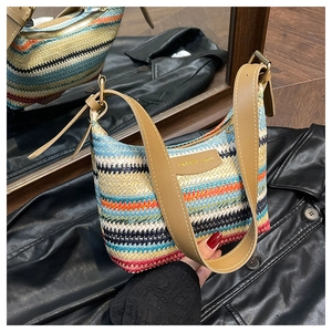 Macro shot of colorful striped woven fabric detail and brown leather strap on a chic handbag