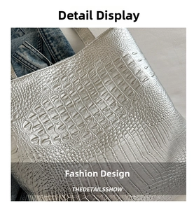 Close-up of metallic silver crocodile embossed texture on a large capacity tote bag