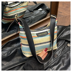 Detail of colorful woven shoulder bag with striped pattern and leather strap