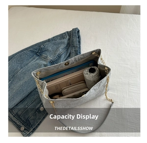 Top view of large grey tote bag interior with tablet, umbrella and phone for daily commute