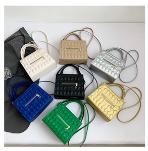 Flat lay of quilted crossbody bags in seven vibrant colors with crossbody straps