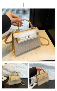 Dettaglio della borsa a mano trapezoidale oro con pelle metallizzata, glitter e chiusura