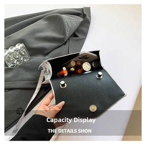 Detail showing internal capacity of the white floral printed crossbody bag with essentials
