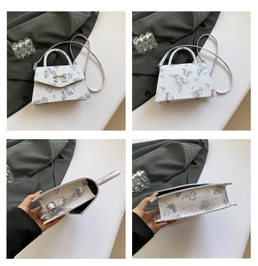 Detail showing white tote bag with butterfly prints and golden bow clasp mechanism