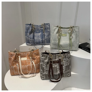 Plaid canvas tote bags in four colors with gold chain handles and abstract patterns