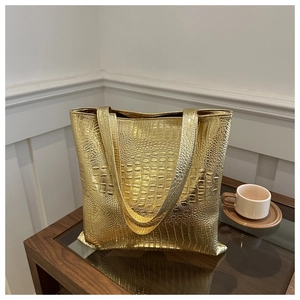 Close-up of the crocodile embossed texture on this gold metallic large tote handbag