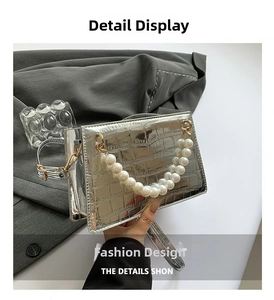 Detail of silver crocodile pattern handbag featuring a luxury faux pearl beaded handle