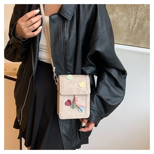 Detail of beige crossbody phone bag with colorful heart decor and Fashion Bags logo