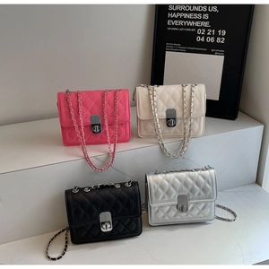 Quilted crossbody bags in pink, white, black and silver shown on a tiered display