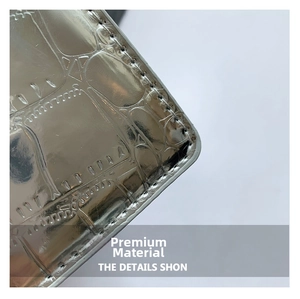 Detailed macro view of silver metallic embossed leather texture and precise black stitching