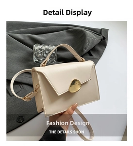 Close-up of cream leather mini square bag with golden oval buckle and fine shoulder strap