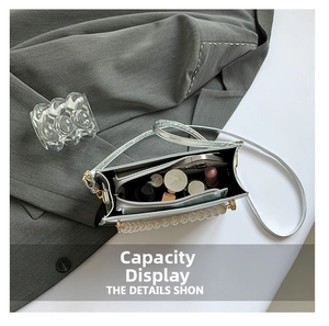Silver metallic bag with pearl handle showing spacious interior compartment for makeup