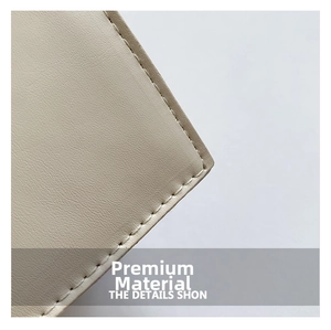 Close-up of off-white lychee pattern leather texture with precise stitching on a fashion bag