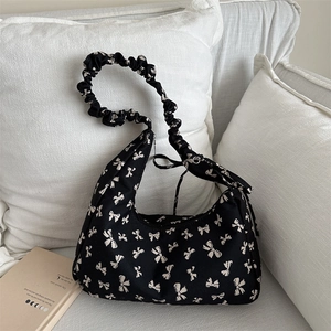 Chic black canvas hobo bag with bow prints and ruched shoulder strap for casual wear