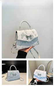 Detailed views of white butterfly print crossbody bag with silver bow clasp and strap