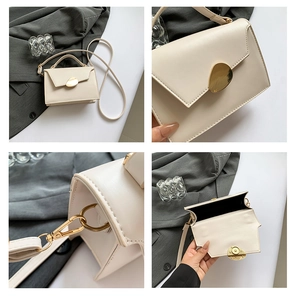 Detail of minimalist beige leather bag featuring golden hardware and magnetic closure