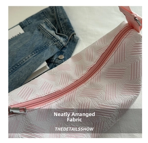 Detailed close-up of pink and white textured woven shoulder bag with durable zipper