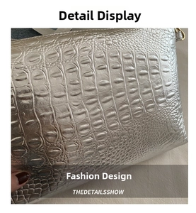 Close-up of silver crocodile embossed texture on a large capacity fashion handbag