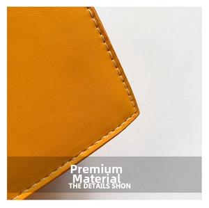 Detail shot of bright orange leather texture with precise white contrast stitching