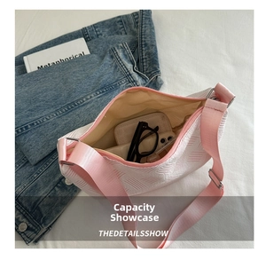 Internal view of pink canvas crossbody bag showing space for phone and accessories