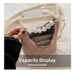 Detail showing internal large capacity of pink shoulder bag with pearl beaded handle