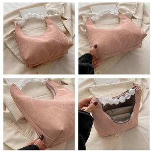 Detail of pink marble pattern handbag featuring elegant white beaded handle and zipper