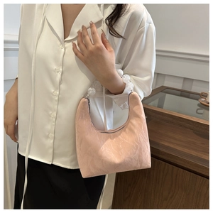 Detail of pink pleated crescent bag with transparent acrylic beaded handle and metal zipper