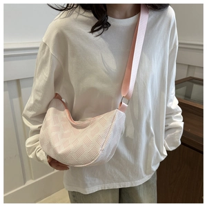 Detail of pink and white woven pillow bag showing textured fabric and wide strap