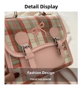 Detail of pink plaid backpack with embroidered bow and silver metallic buckles