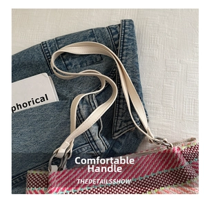 Detail showing high-quality white leather handle and colorful woven texture of the bag