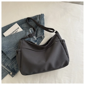 Macro shot of charcoal grey large tote bag with zipper pockets and nylon texture details