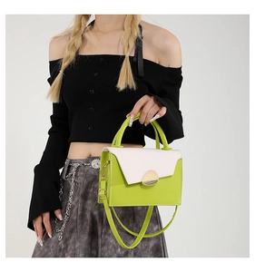 Détail du sac à main bicolore vert citron avec rabat crème et fermoir doré chic
