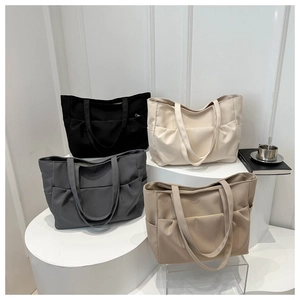 Détail de grands sacs fourre-tout en toile avec poches latérales en quatre couleurs