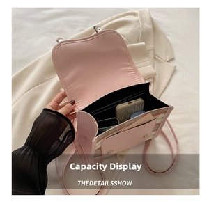 Detail show of the spacious interior of pink PU leather crossbody bag with plaid pattern