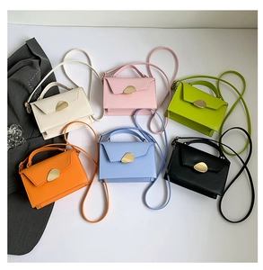 Close-up of minimalist leather crossbody bags in six colors with gold metal buckles