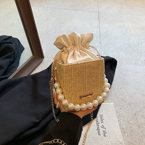 Chic woven pearl bucket bag with gold chain strap and drawstring liner for women