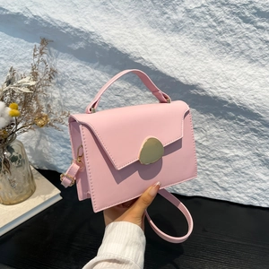Pink minimalist crossbody handbag with a stylish gold metal clasp and top handle for women