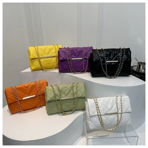V-quilted chain strap crossbody bags in six vibrant colors displayed on white steps