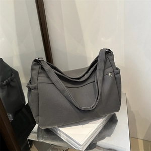 Deep grey large capacity canvas tote bag with functional side pockets and silver hardware