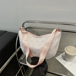 Minimalist white textured crescent crossbody bag with adjustable pink wide shoulder strap