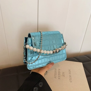 Mini flap handbag in metallic blue croc leather with pearl chain and heart charms