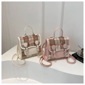 Close-up of retro plaid handbags with metal buckles and elegant bow embroidery