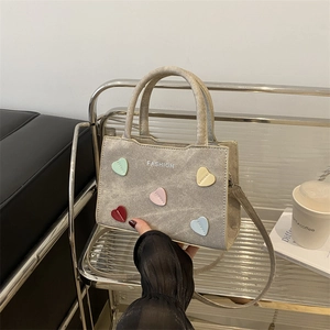 Chic grey canvas bucket bag with colorful 3D heart charms and long shoulder strap
