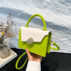 Sac à main contrasté vert néon et blanc avec boucle dorée et poignée ronde tendance