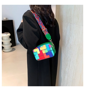 Detail of colorful geometric block crossbody bag with ethnic style wide shoulder strap